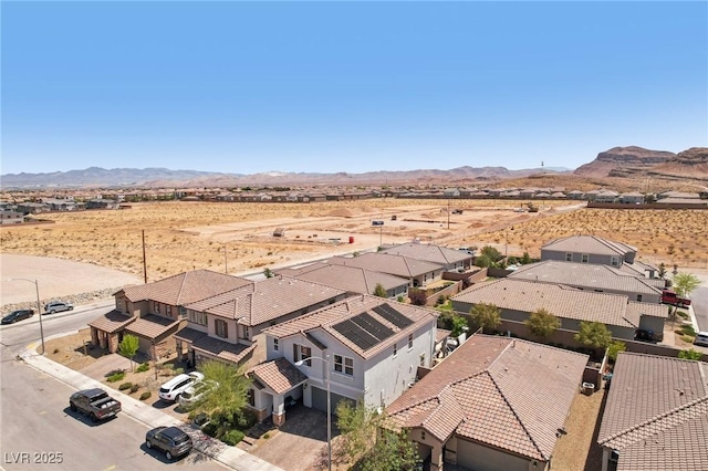 drone / aerial view with a mountain view, a rural view, a residential view, and a desert view
