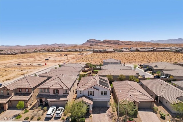 birds eye view of property with a desert view, a mountain view, and a residential view