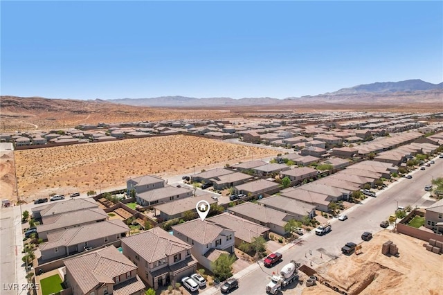 aerial view featuring a residential view, a mountain view, and view of desert