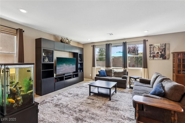 living room featuring visible vents and recessed lighting