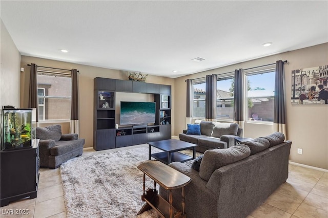 living room with recessed lighting, light tile patterned flooring, and baseboards