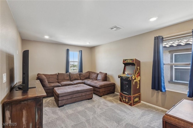 living room featuring baseboards, visible vents, light carpet, and recessed lighting
