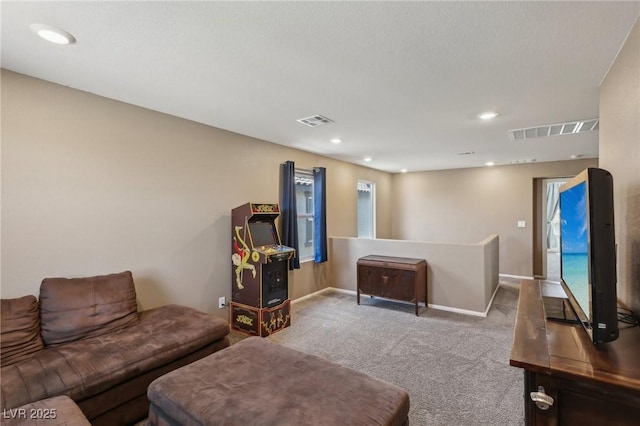 living room with visible vents, recessed lighting, and carpet flooring