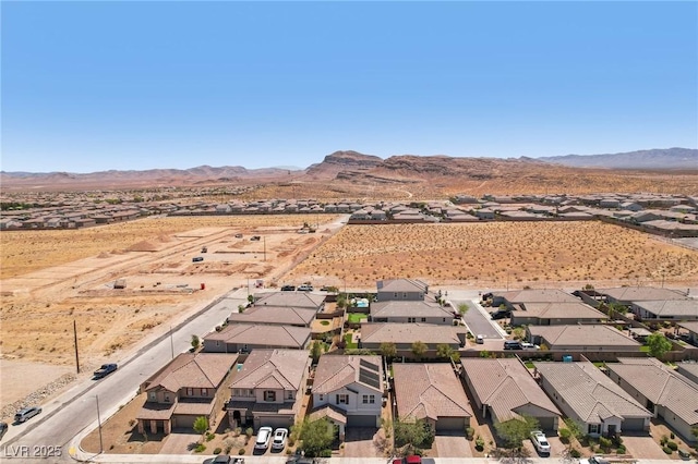 drone / aerial view with a mountain view, a residential view, and a desert view