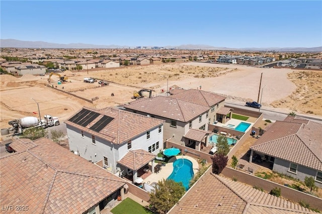 birds eye view of property with a mountain view and a residential view