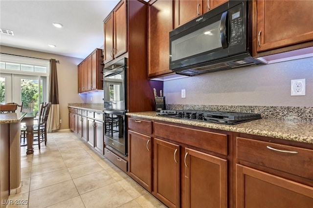 kitchen featuring recessed lighting, brown cabinetry, black appliances, visible vents, and light tile patterned flooring