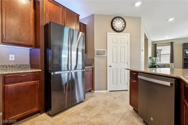 kitchen with recessed lighting, light tile patterned floors, appliances with stainless steel finishes, and light stone counters