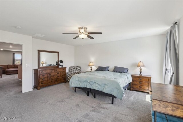 carpeted bedroom featuring ceiling fan and visible vents
