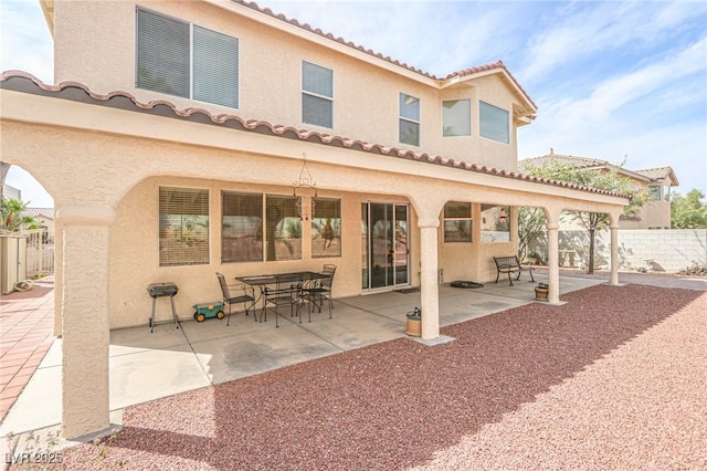 back of property with stucco siding and a patio area