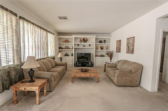 living room with carpet and visible vents