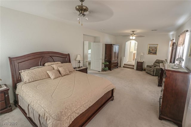 bedroom with a ceiling fan and light colored carpet