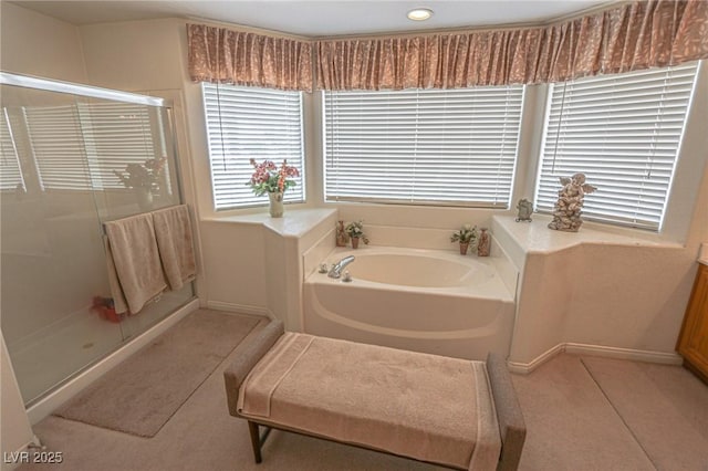 full bathroom featuring a stall shower and a garden tub