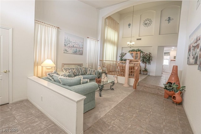 living room with a high ceiling and a chandelier