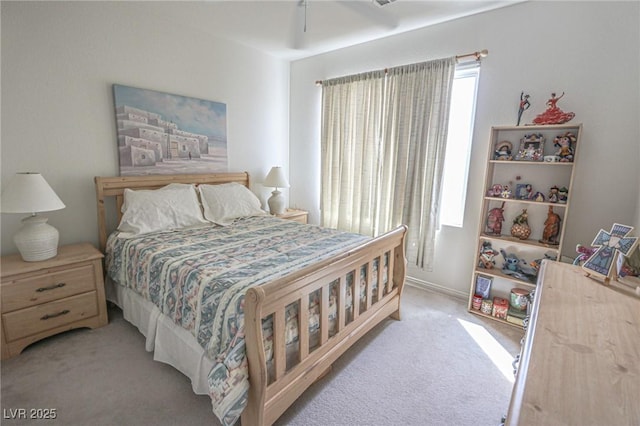 bedroom with a ceiling fan and light carpet
