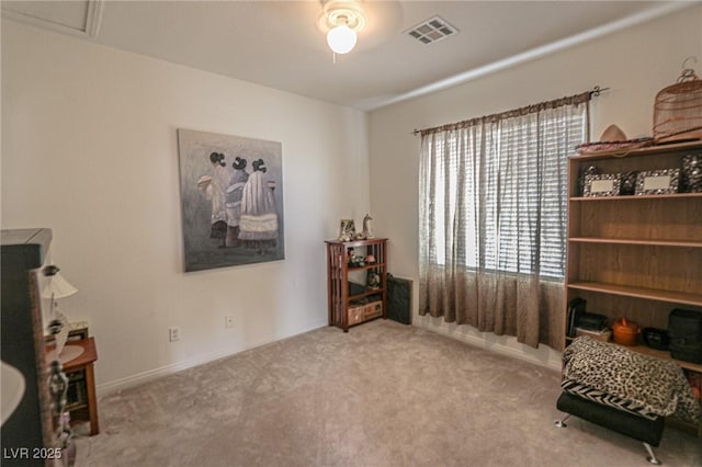 sitting room featuring carpet floors, baseboards, ceiling fan, and visible vents