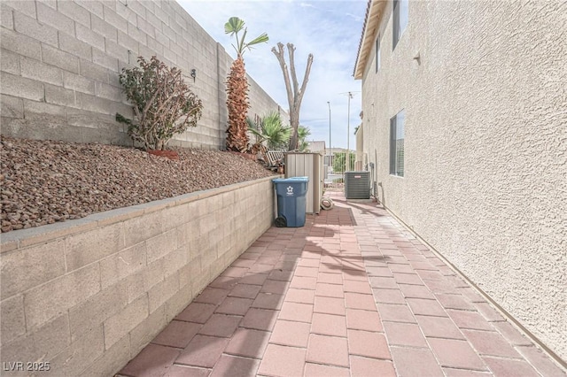 view of patio / terrace featuring central air condition unit and fence
