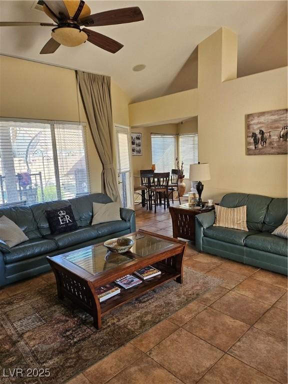 tiled living room with vaulted ceiling and ceiling fan