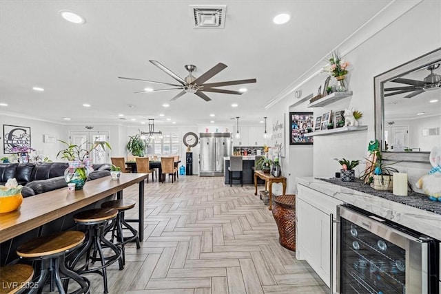 dining space featuring wine cooler, crown molding, a ceiling fan, and recessed lighting
