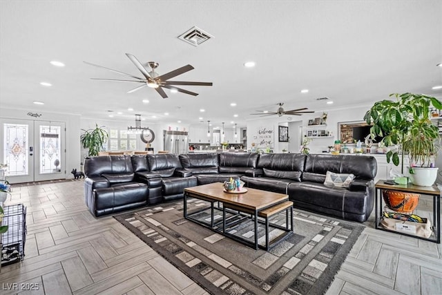 living area featuring visible vents, ornamental molding, recessed lighting, french doors, and a ceiling fan