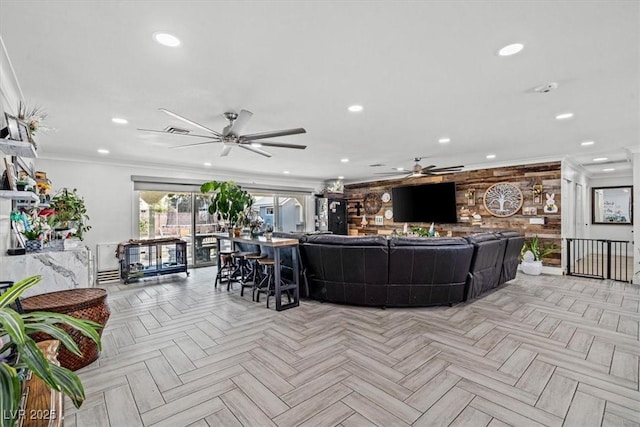 living room with recessed lighting, ornamental molding, ceiling fan, and visible vents
