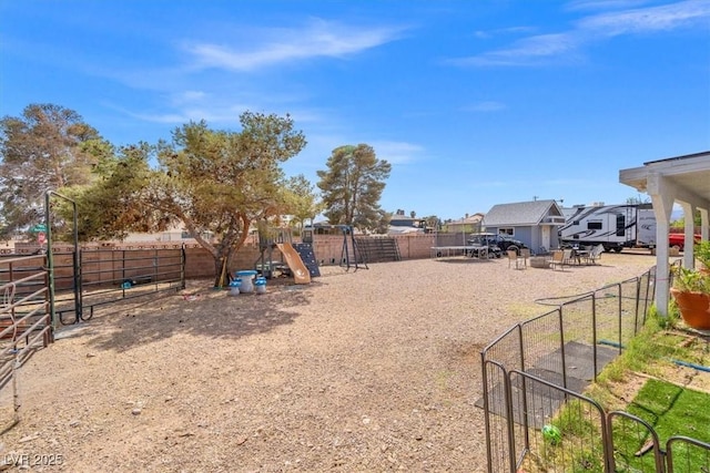 view of yard featuring fence and a playground