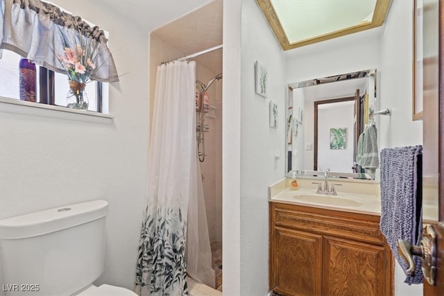 full bathroom featuring vanity, a shower stall, and toilet
