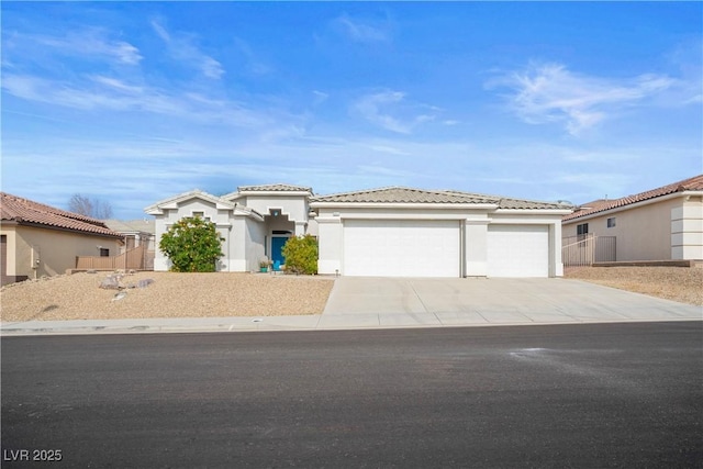 3491 Cottage Thistle Dr, Laughlin, NV 89029 - prairie-style home with a tile roof, stucco siding, an attached garage, and concrete driveway