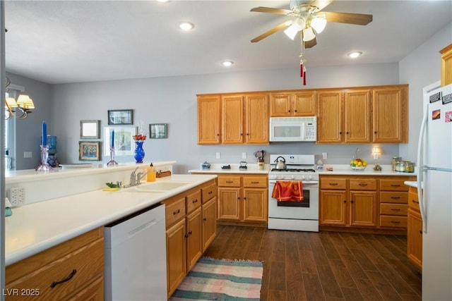 3491 Cottage Thistle Dr, Laughlin, NV 89029 - kitchen with light countertops, white appliances, recessed lighting, dark wood-type flooring, and a sink
