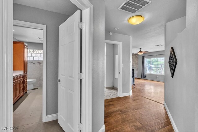 4678 Saddle Pl, Las Vegas, NV 89119 - hallway featuring light wood-type flooring and baseboards