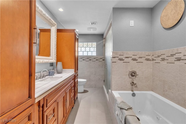 4678 Saddle Pl, Las Vegas, NV 89119 - bathroom with toilet, tile walls, vanity, a tub with jets, and a stall shower
