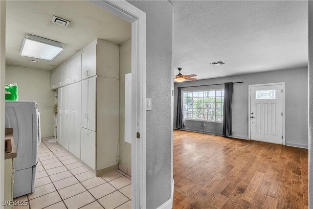 4678 Saddle Pl, Las Vegas, NV 89119 - hall featuring washer / clothes dryer, light wood finished floors, and baseboards