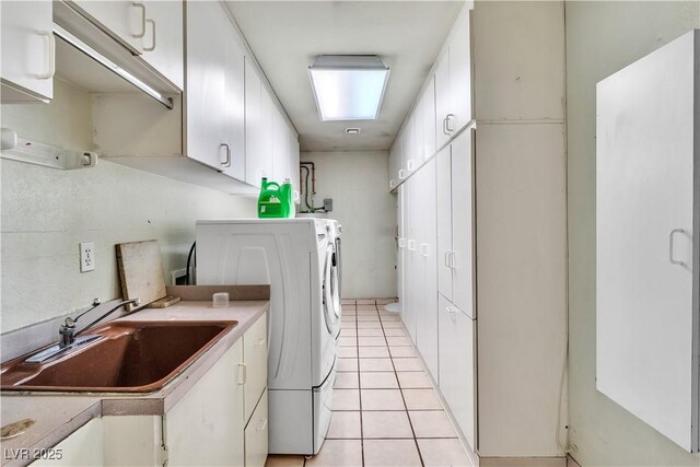 4678 Saddle Pl, Las Vegas, NV 89119 - laundry room featuring separate washer and dryer, cabinet space, and light tile patterned floors