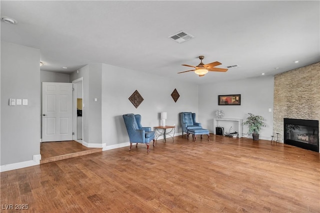 4678 Saddle Pl, Las Vegas, NV 89119 - living area with wood finished floors, a fireplace, ceiling fan, baseboards, and recessed lighting