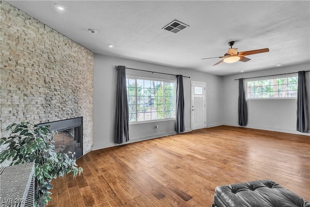 4678 Saddle Pl, Las Vegas, NV 89119 - unfurnished living room featuring wood finished floors, a ceiling fan, a fireplace, and recessed lighting