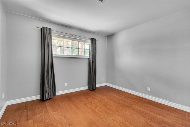 4678 Saddle Pl, Las Vegas, NV 89119 - unfurnished room featuring wood finished floors and baseboards