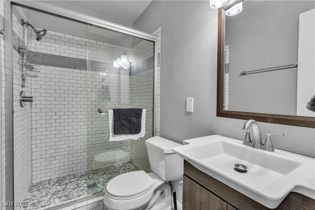 4678 Saddle Pl, Las Vegas, NV 89119 - bathroom with toilet, a stall shower, vanity, and a textured wall