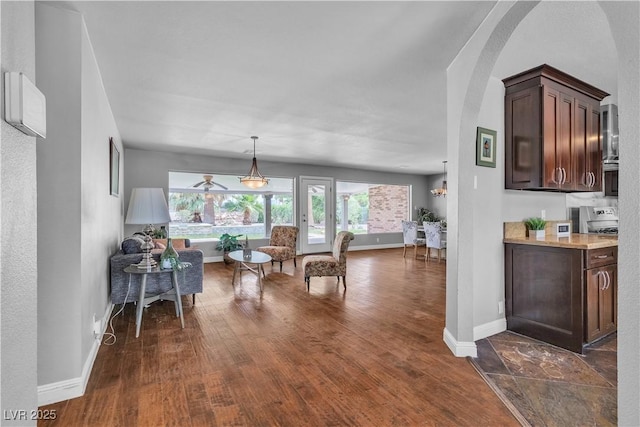 4678 Saddle Pl, Las Vegas, NV 89119 - interior space featuring baseboards, dark wood-style floors, and arched walkways