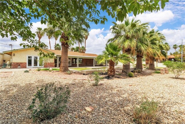 4678 Saddle Pl, Las Vegas, NV 89119 - back of property featuring brick siding, french doors, a patio area, and stucco siding