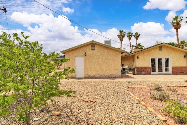 4678 Saddle Pl, Las Vegas, NV 89119 - rear view of house with french doors, stucco siding, and a patio