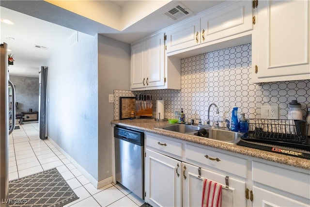 4678 Saddle Pl, Las Vegas, NV 89119 - kitchen with dishwasher, a sink, light tile patterned floors, backsplash, and white cabinetry