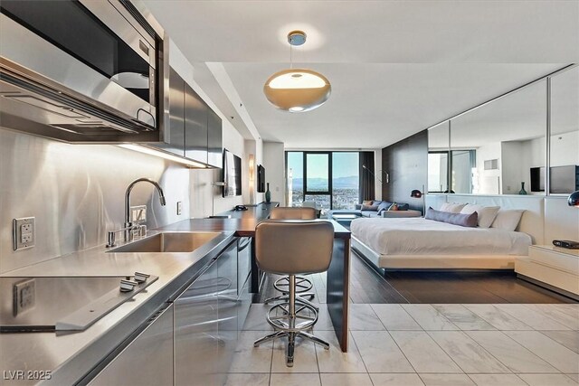4381 W Flamingo Rd Unit 1609, Las Vegas, NV 89103 - bedroom featuring a wall of windows and a sink