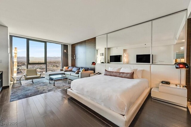 4381 W Flamingo Rd Unit 1609, Las Vegas, NV 89103 - bedroom featuring floor to ceiling windows and wood finished floors