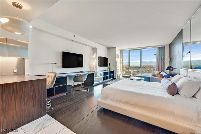 4381 W Flamingo Rd Unit 1609, Las Vegas, NV 89103 - bedroom with a wall of windows and wood finished floors