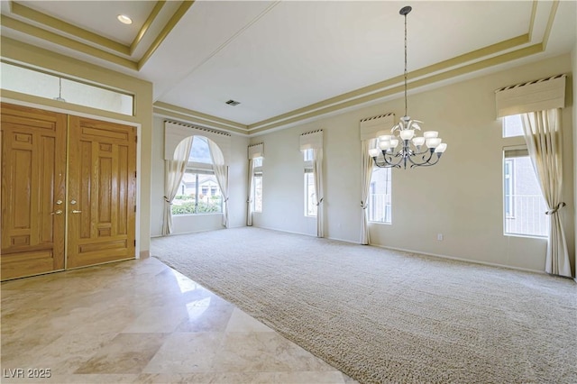 2212 Sierra Heights Dr, Las Vegas, NV 89134 - entrance foyer featuring a tray ceiling, light carpet, baseboards, visible vents, and an inviting chandelier