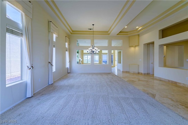 2212 Sierra Heights Dr, Las Vegas, NV 89134 - spare room with a high ceiling, a notable chandelier, baseboards, and a wealth of natural light