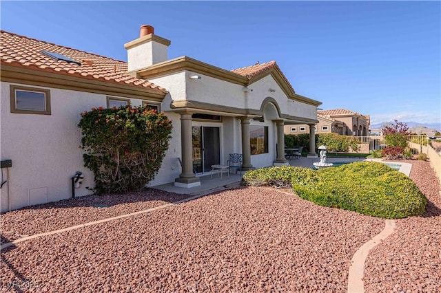2212 Sierra Heights Dr, Las Vegas, NV 89134 - rear view of house featuring a tile roof, stucco siding, fence, and a patio