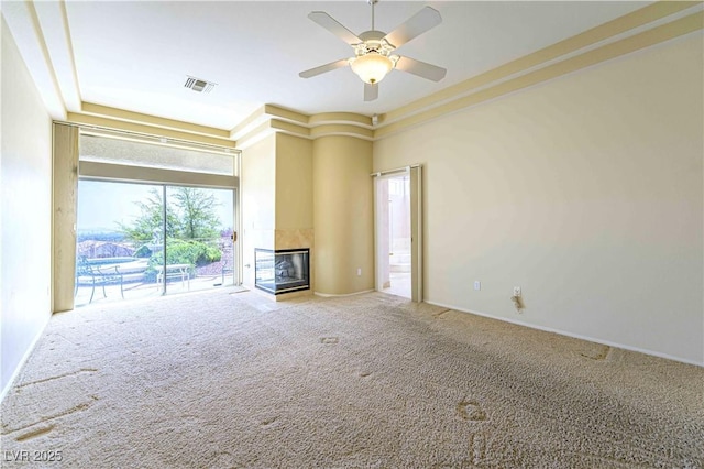 2212 Sierra Heights Dr, Las Vegas, NV 89134 - unfurnished living room featuring carpet flooring, visible vents, a tile fireplace, baseboards, and ceiling fan