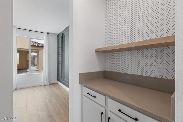 interior space with light wood finished floors and baseboards