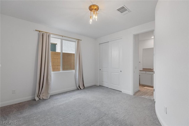 interior space featuring baseboards, visible vents, and carpet floors