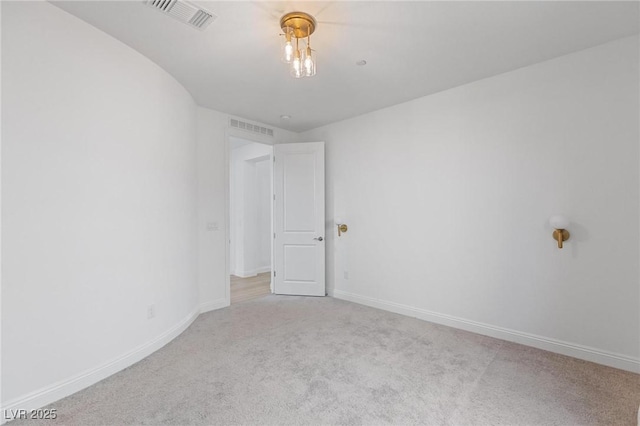 spare room with visible vents, baseboards, and carpet floors